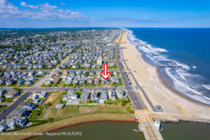 Aerial view of lagoon-front homes in Point Pleasant Beach, NJ, featuring private boat docks and luxury waterfront real estate near the Barnegat Peninsula.