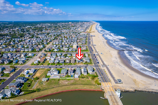 Aerial view of lagoon-front homes in Point Pleasant Beach, NJ, featuring private boat docks and luxury waterfront real estate near the Barnegat Peninsula.